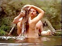 Vintage movie of a sexy female actress getting nude and bath in a river with her friend.